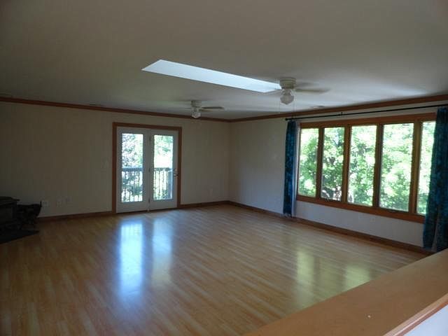 2580 Van Dyke Road Minooka, IL 60447 - Photo 26 of 32 a view of an empty room with wooden floor and a window