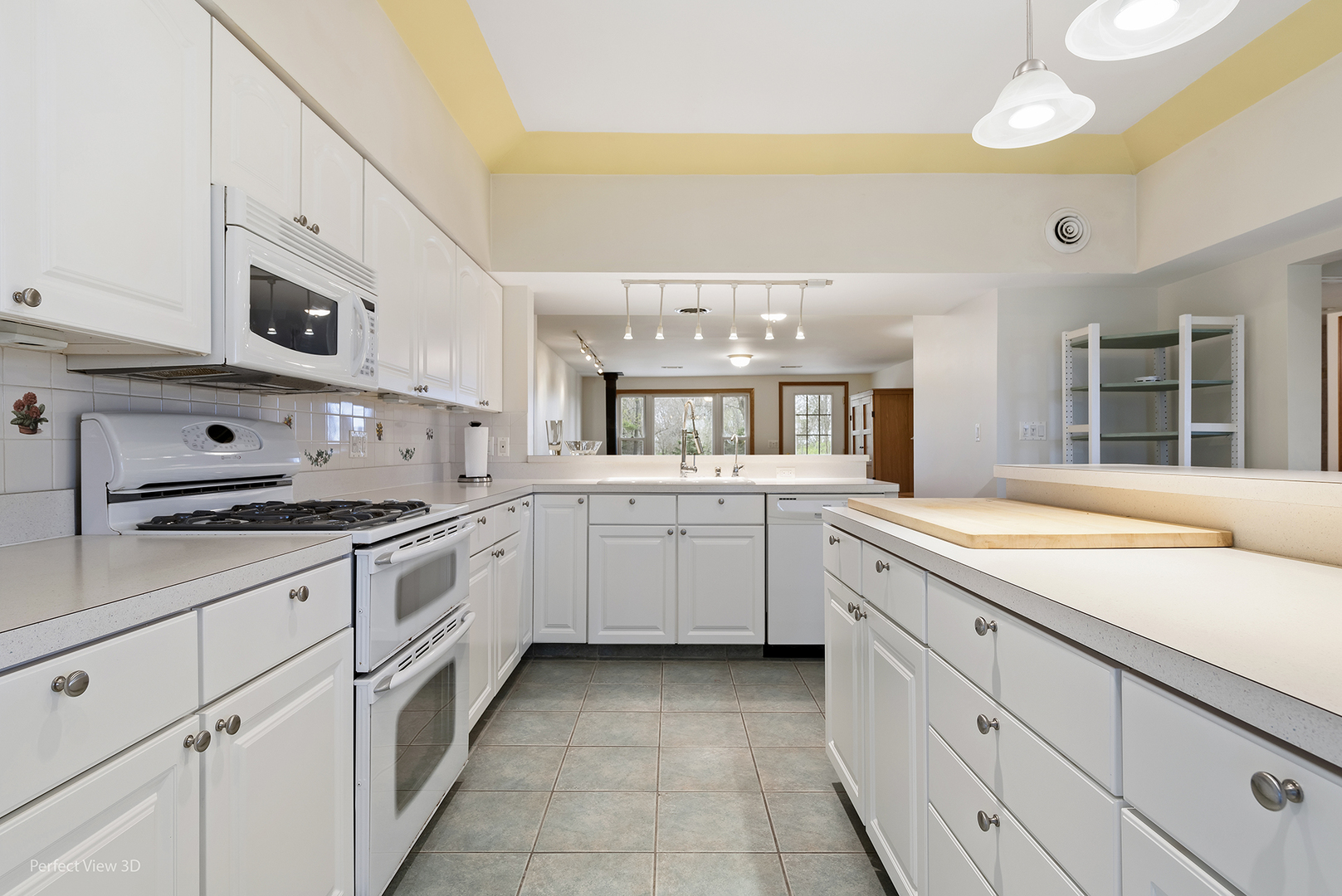 2580 Van Dyke Road Minooka, IL 60447 - Photo 7 of 32 a large white kitchen with stainless steel appliances granite countertop a stove and a sink