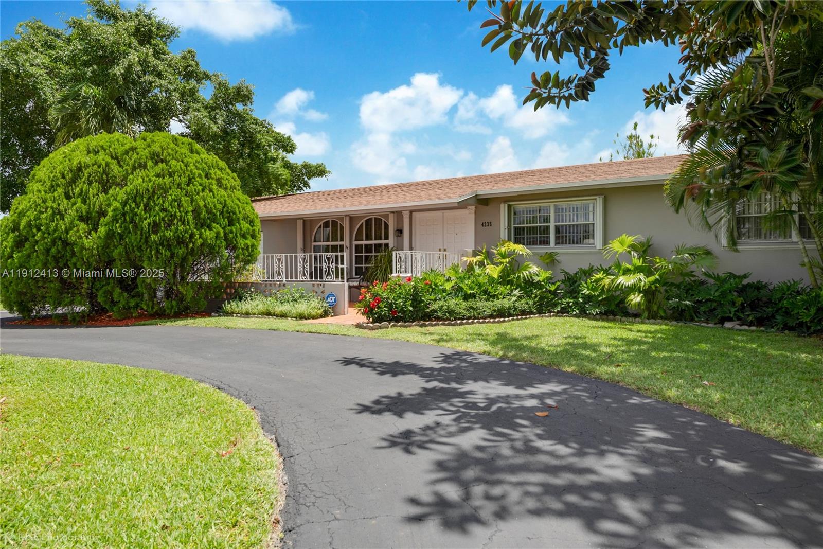 a front view of house with yard and green space