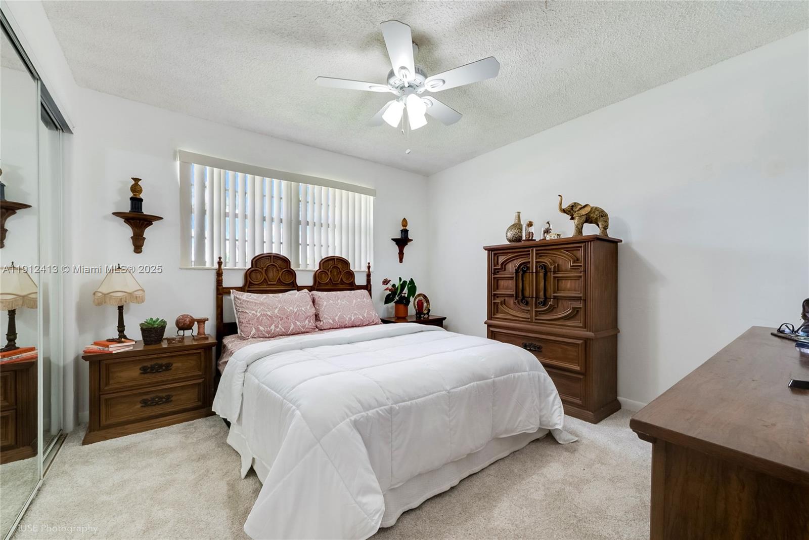 4235 Southwest 97th Avenue Miami, FL 33165 - Photo 13 of 21 a bedroom with a bed and a chandelier