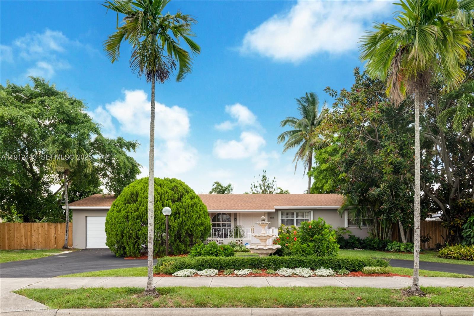 4235 Southwest 97th Avenue Miami, FL 33165 - Photo 18 of 21 a front view of a house with plants and palm trees