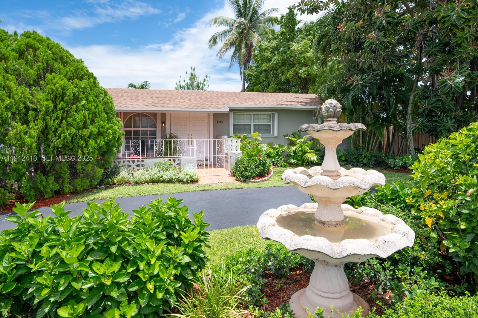 4235 Southwest 97th Avenue Miami, FL 33165 - Photo 19 of 21 front view of a house with a yard