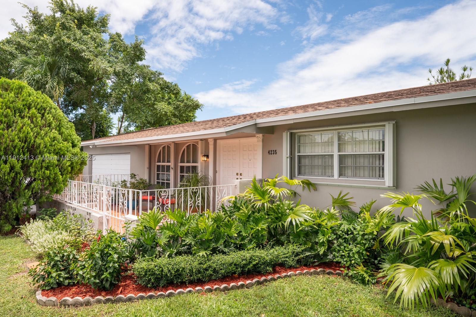 4235 Southwest 97th Avenue Miami, FL 33165 - Photo 20 of 21 front view of house with a yard