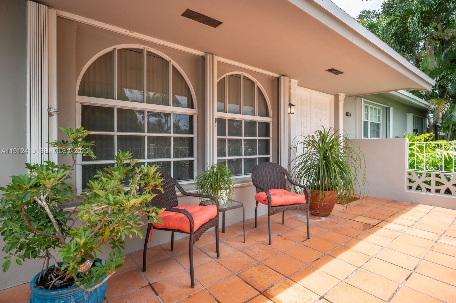 4235 Southwest 97th Avenue Miami, FL 33165 - Photo 2 of 21 a view of a chair and table in back yard of the house