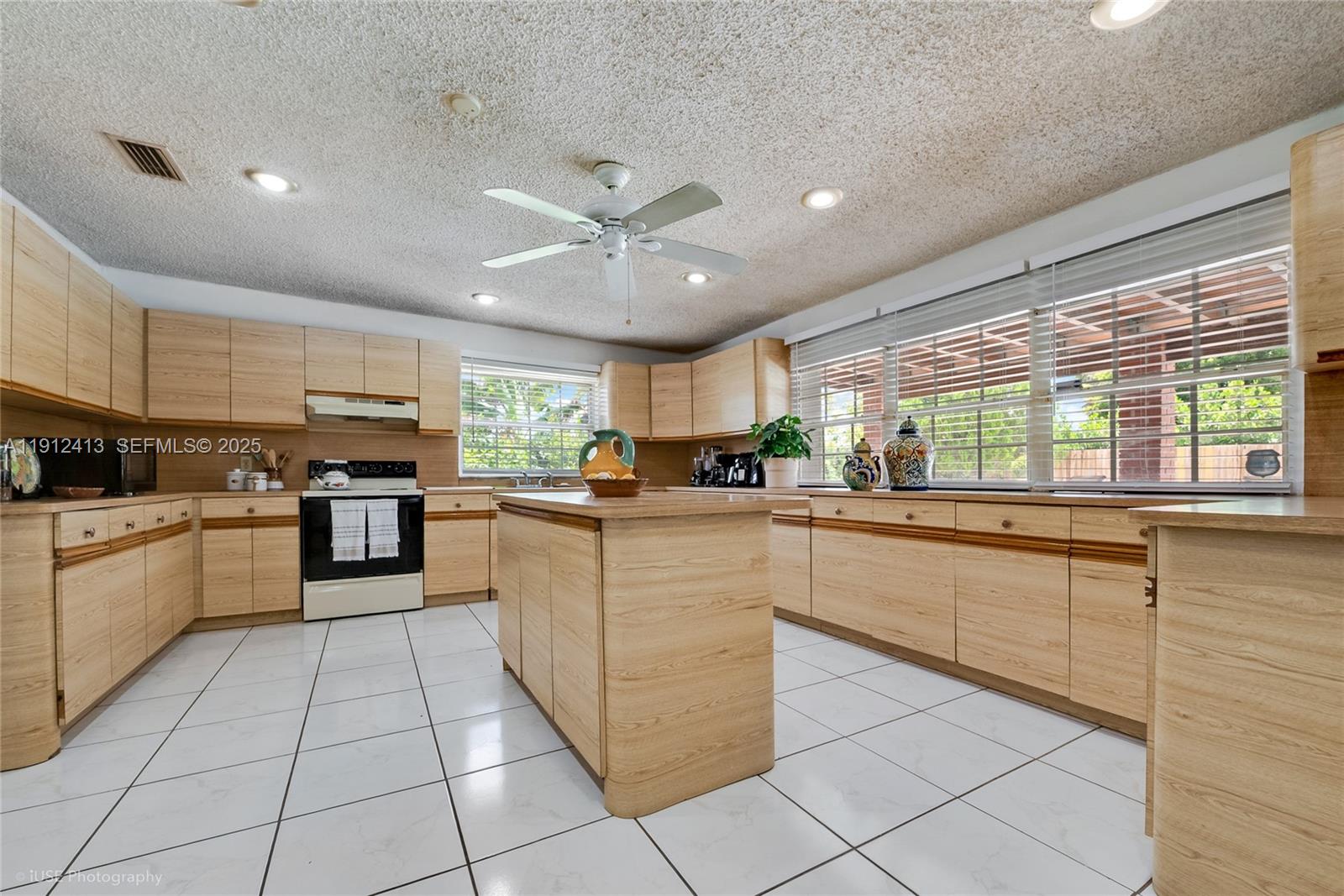 4235 Southwest 97th Avenue Miami, FL 33165 - Photo 7 of 21 a kitchen with stainless steel appliances granite countertop a stove and cabinets