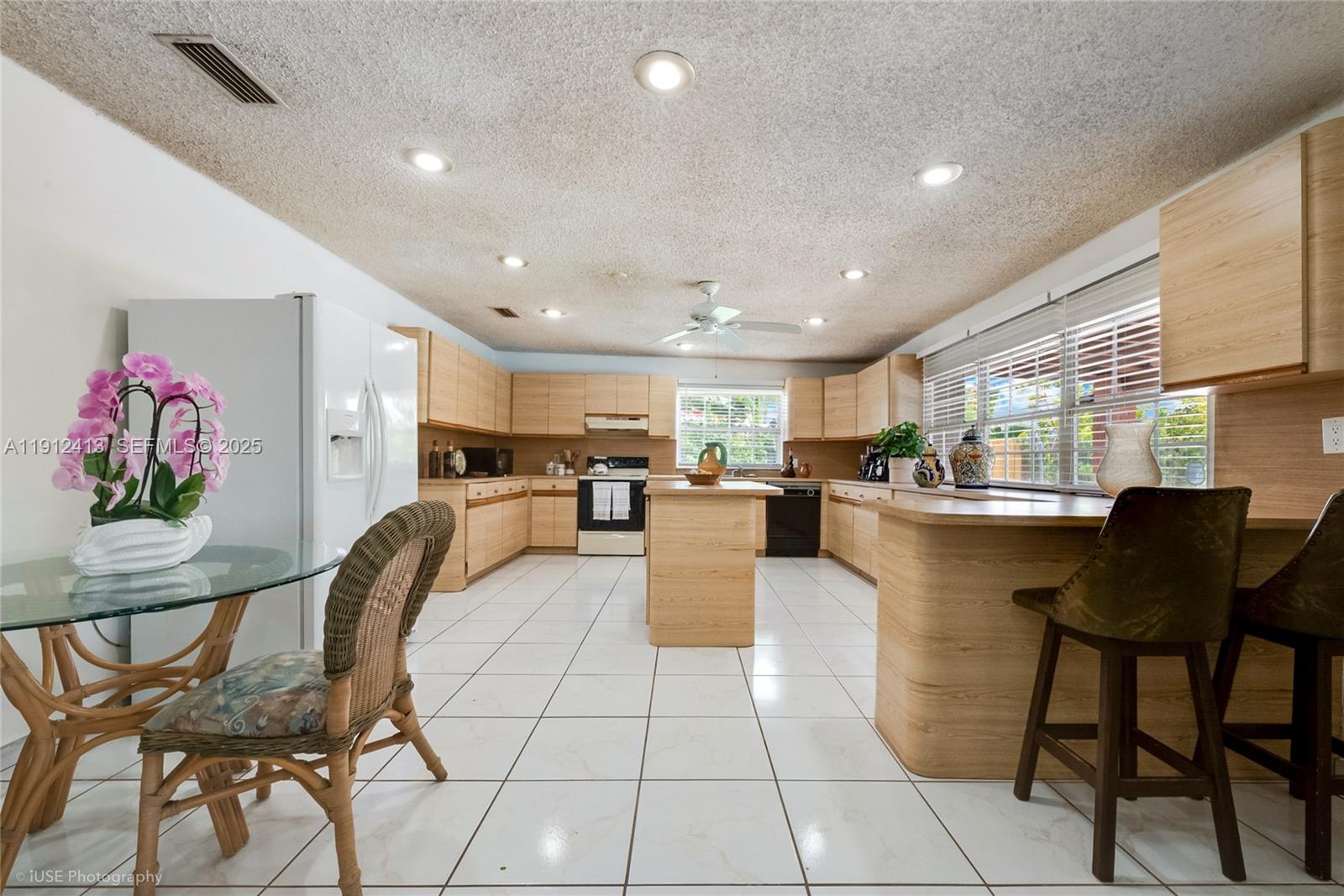 4235 Southwest 97th Avenue Miami, FL 33165 - Photo 8 of 21 a living room with furniture a dining table and chairs