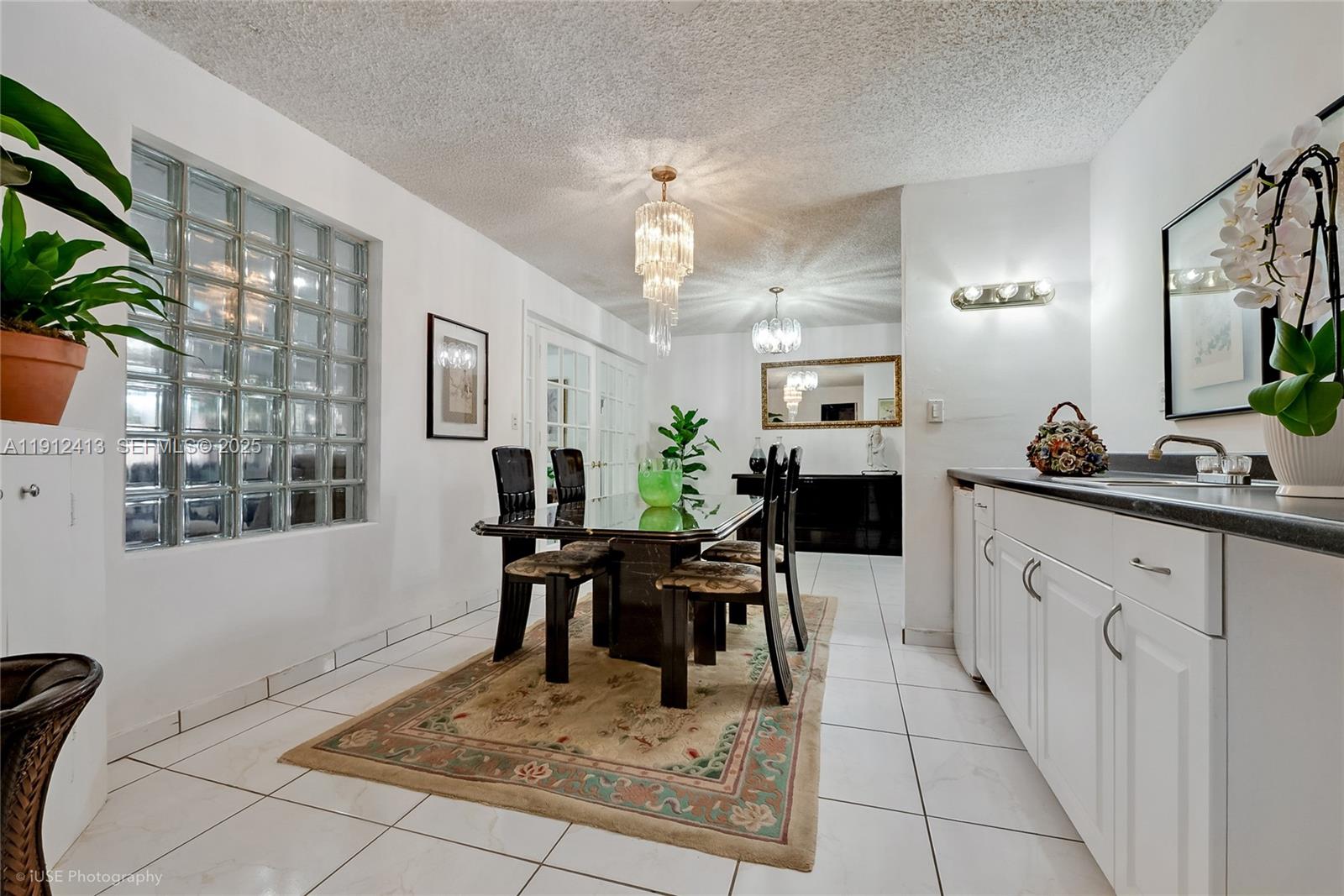 4235 Southwest 97th Avenue Miami, FL 33165 - Photo 9 of 21 a living room with furniture a fireplace and a chandelier