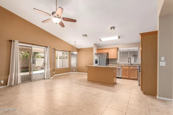a large white kitchen with a large window cabinets and appliances