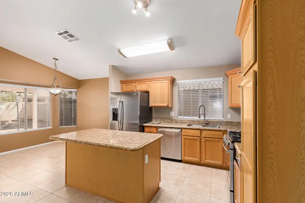 a large kitchen with a sink and cabinets
