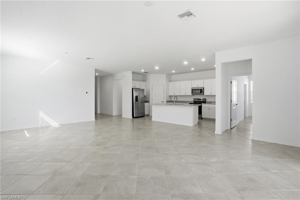 3958 Button Sage Road Alva, FL 33920 - Photo 6 of 50 Unfurnished living room featuring baseboards and recessed lighting