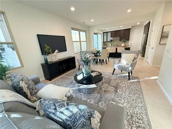 a living room with furniture large window and a flat screen tv