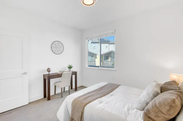 a bathroom with a double vanity sink a toilet and a window