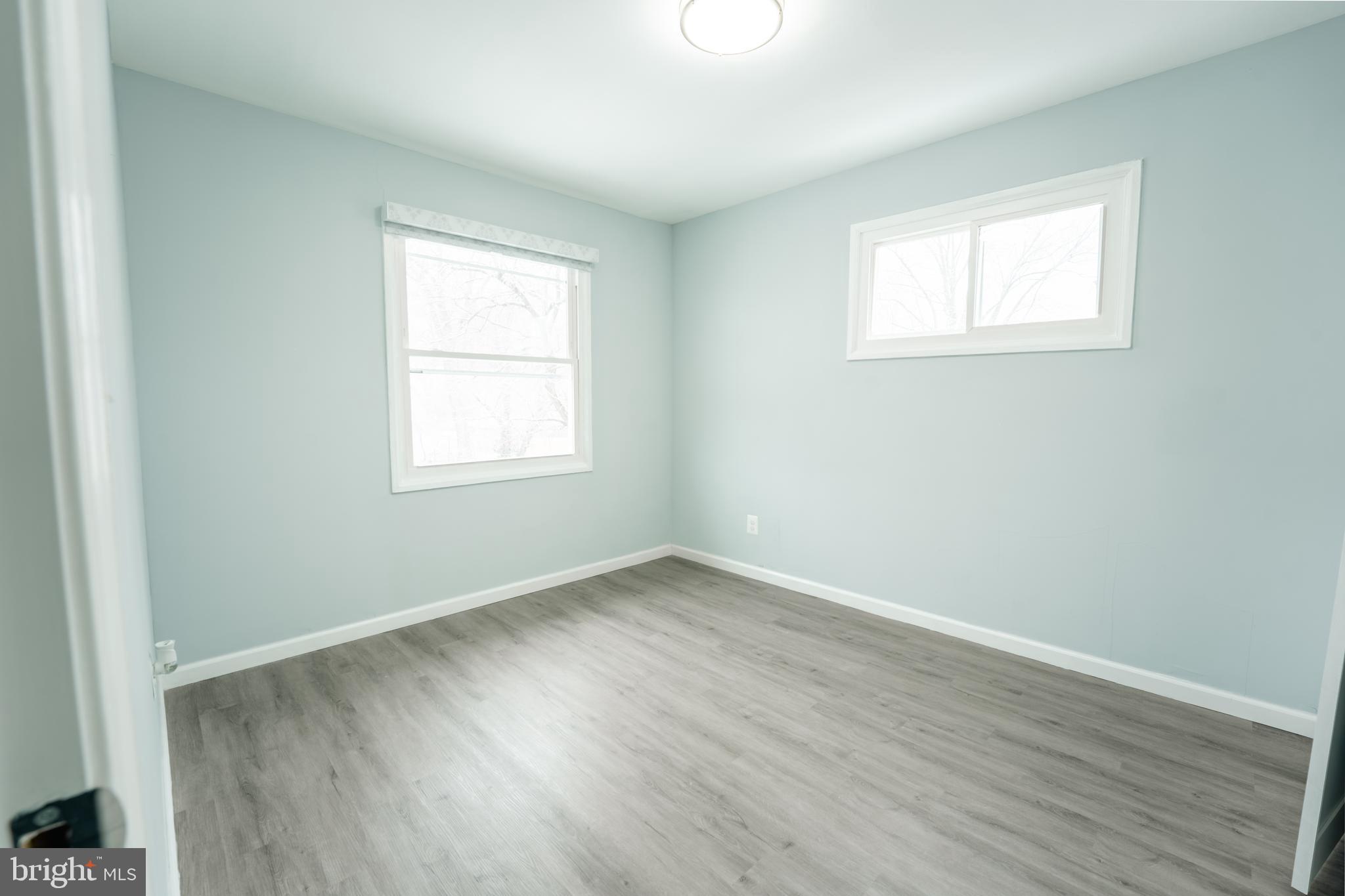 3410 Embry Street Silver Spring, MD 20902 - Photo 11 of 28 an empty room with wooden floor and windows