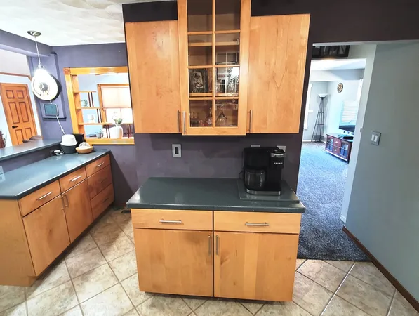 a kitchen with stainless steel appliances granite countertop a refrigerator a sink and a stove