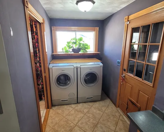 a large bed sitting in a bedroom next to a window