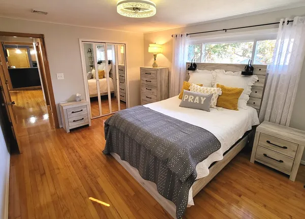 a front view of house with yard and trees in the background