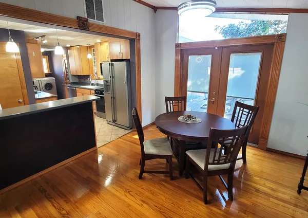 a kitchen with stainless steel appliances granite countertop a refrigerator a stove a sink and a microwave