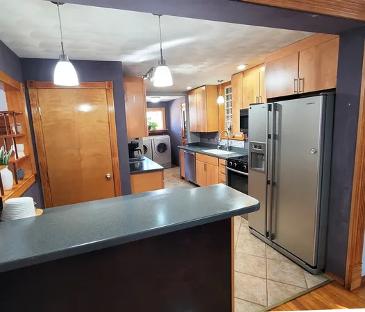 a kitchen with granite countertop a sink and a stove top oven