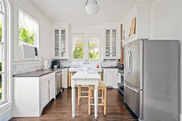 a kitchen with stainless steel appliances a refrigerator sink and cabinets