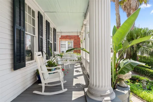 a view of balcony with two chairs and a potted plant