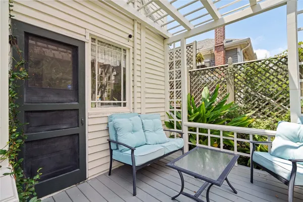 a balcony with furniture and wooden floor