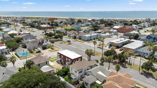 an aerial view of residential building with parking