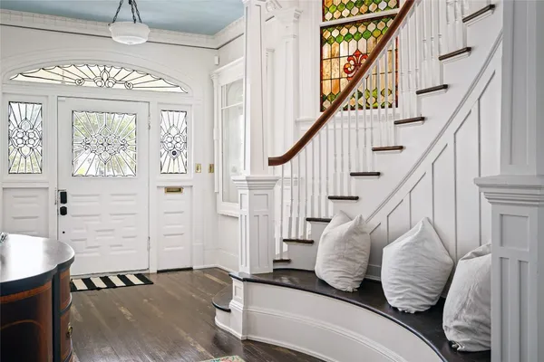 a view of entryway and hall with wooden floor