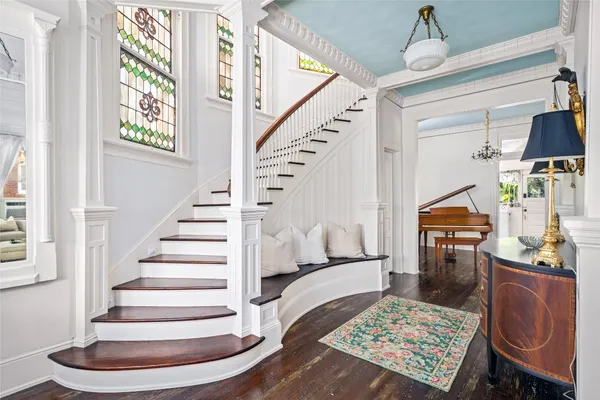 a view of entryway and hall with wooden floor