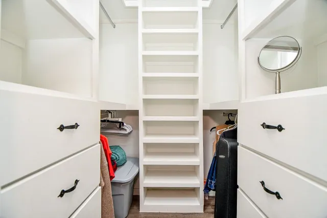 a bathroom with a sink toilet vanity and shower
