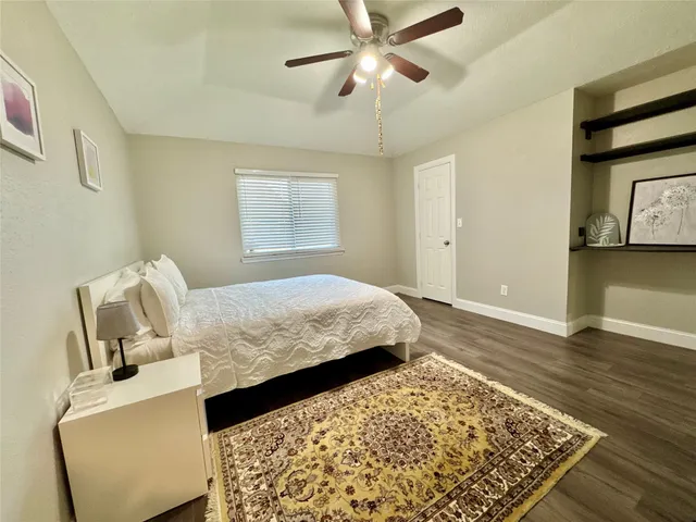 a bedroom with bed and wooden floor