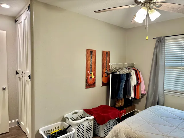 a view of a house with a big yard plants and large tree
