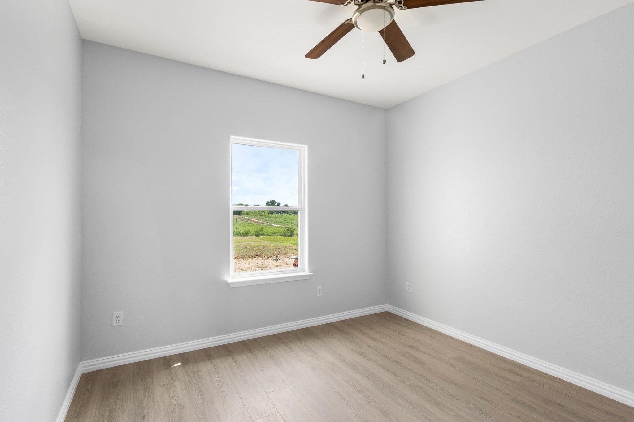 1136 County Road 484 Elgin, TX 78621 - Photo 23 of 37 Spare room with light wood-style floors and ceiling fan