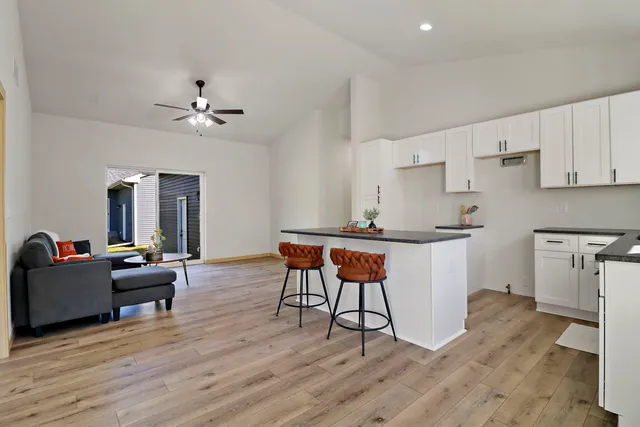 a living room with furniture and a wooden floor