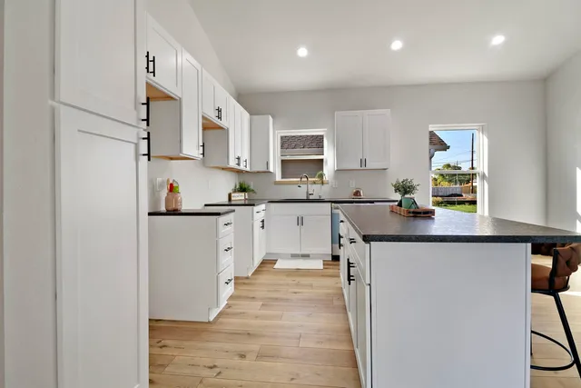 a kitchen with stainless steel appliances granite countertop a sink stove and refrigerator
