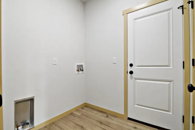 a view of front door with wooden floor