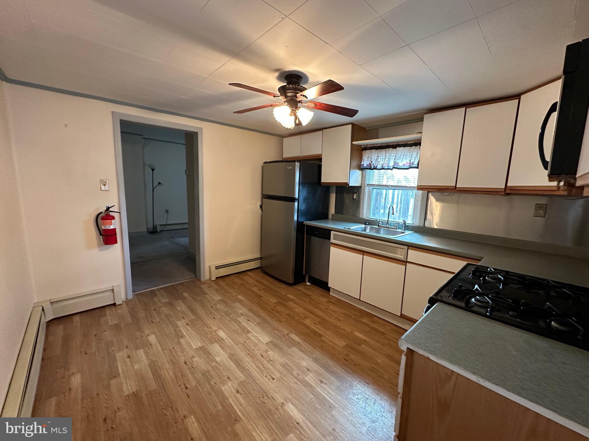 308 A Ash Street Delanco, NJ 08075 - Photo 3 of 11 a kitchen with granite countertop a stove and a refrigerator
