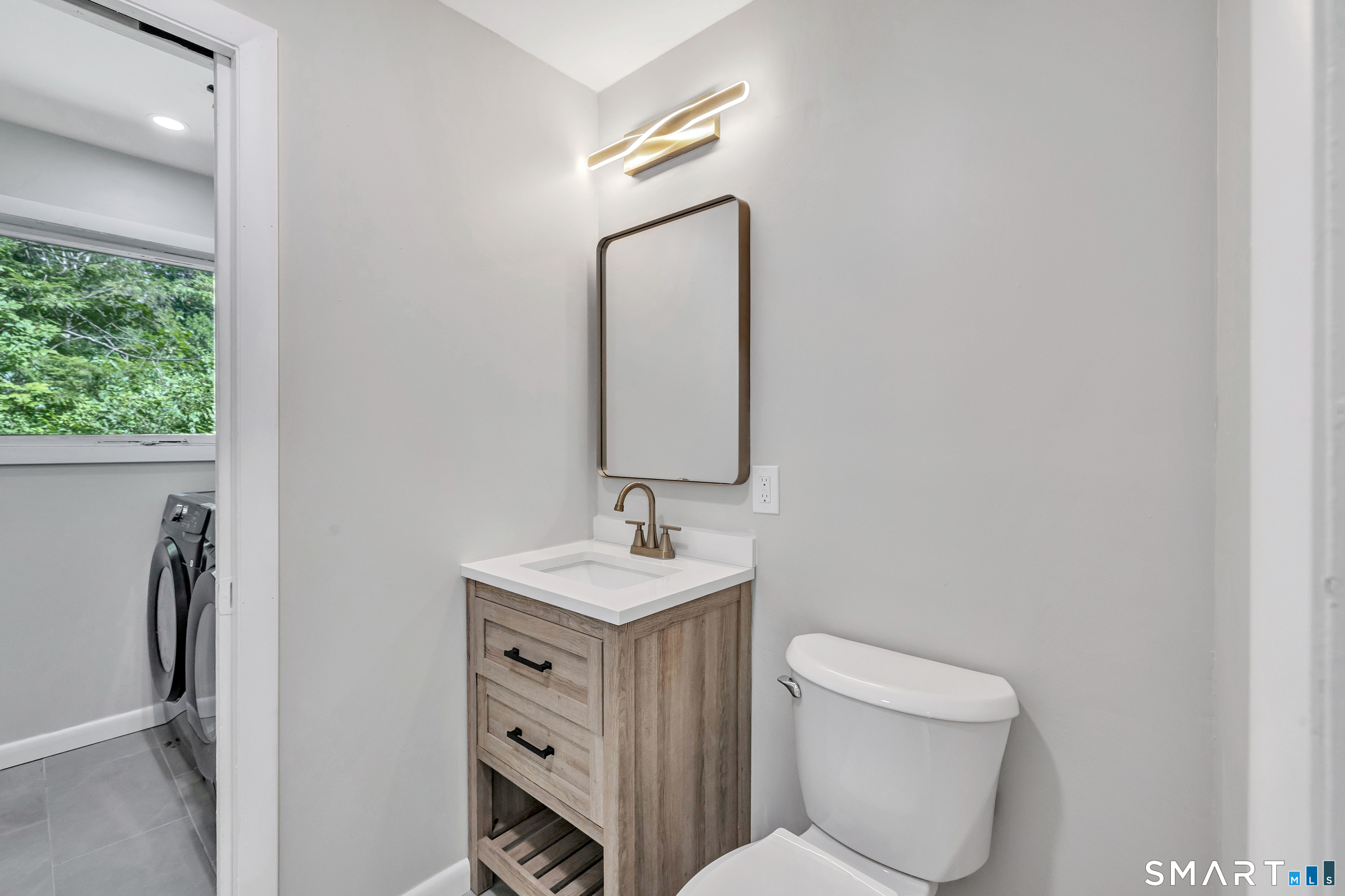 48 Crestwood Road Monroe, CT 06468 - Photo 19 of 32 a bathroom with a toilet sink and mirror