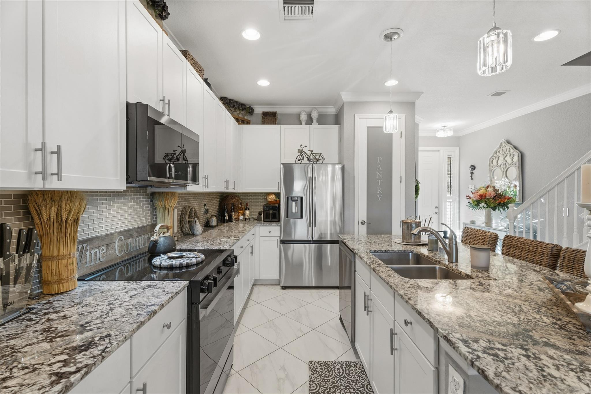 651 Southwest Glen Crest Way, Unit 2 Stuart, FL 34997 - Photo 7 of 41 a kitchen with stainless steel appliances granite countertop a sink stove and refrigerator