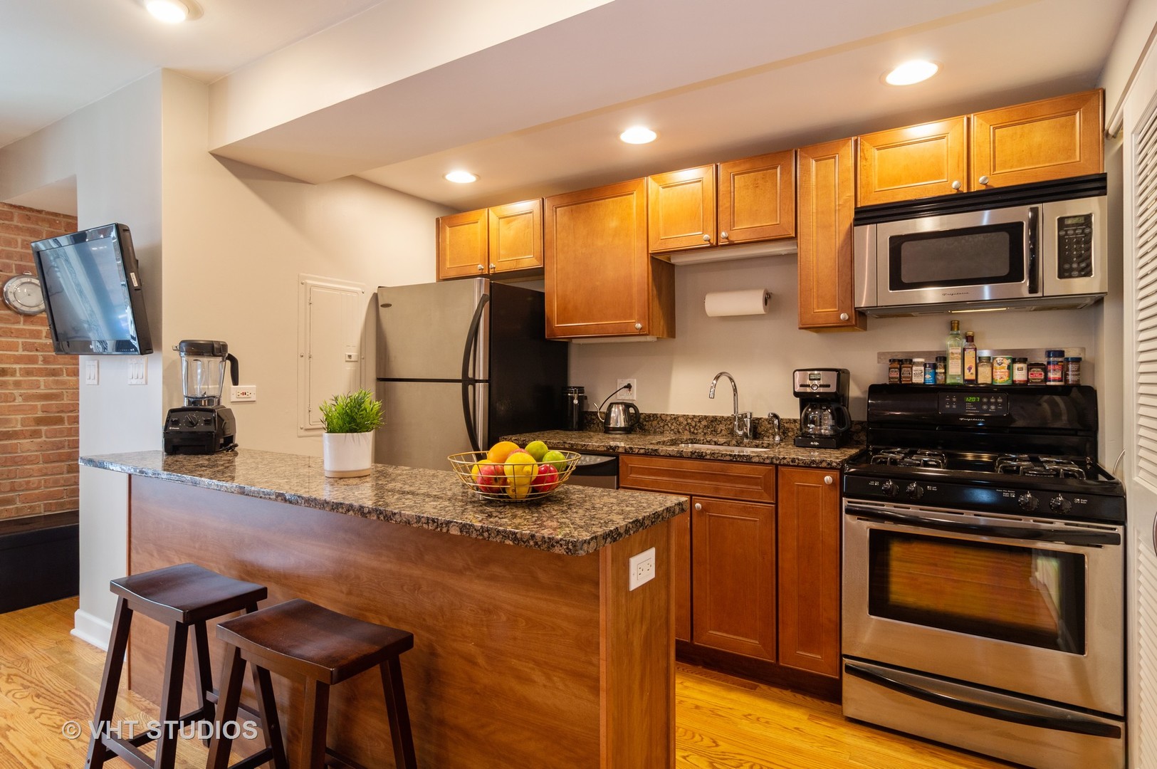 711 West Melrose Street, Unit B2 Chicago, IL 60657 - Photo 9 of 22 a kitchen with stainless steel appliances a stove a sink a microwave a refrigerator and cabinets