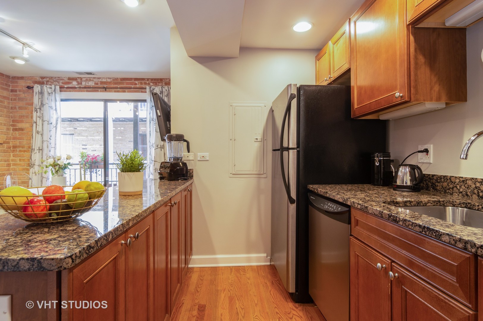 711 West Melrose Street, Unit B2 Chicago, IL 60657 - Photo 10 of 22 a kitchen with stainless steel appliances granite countertop a refrigerator a stove and a sink