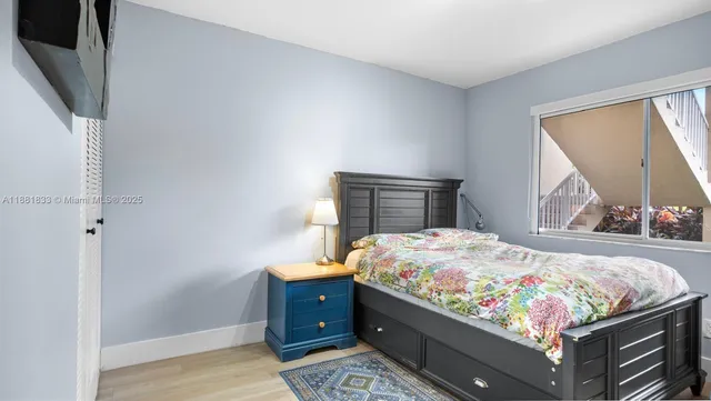 a bedroom with a bed and a lamp