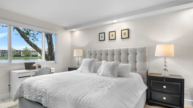 a bedroom with a large bed and a window