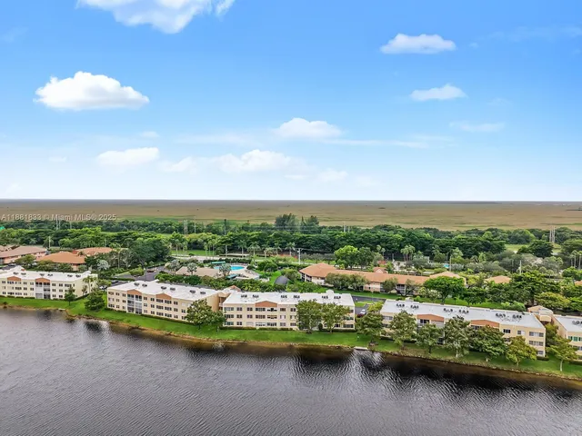 an aerial view of a swimming pool with a yard