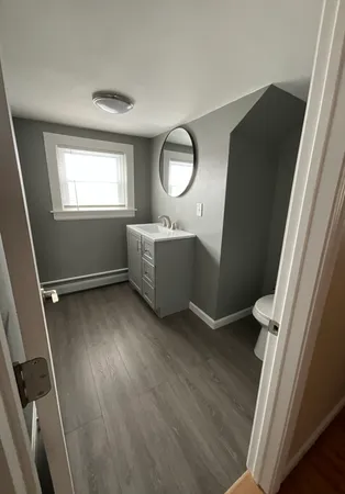 wooden floor in a gallery next to a window