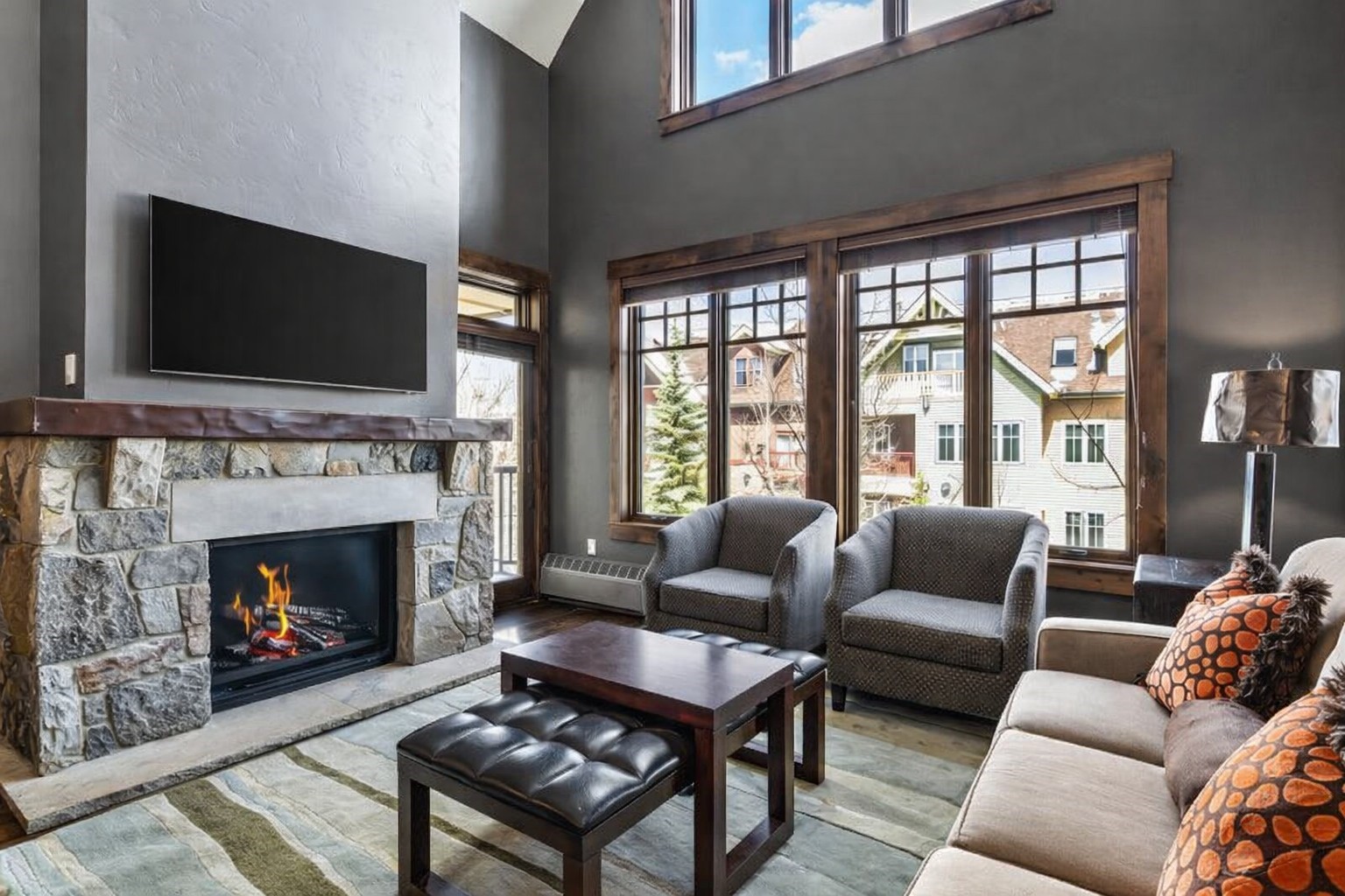 a living room with furniture a flat screen tv and a fireplace