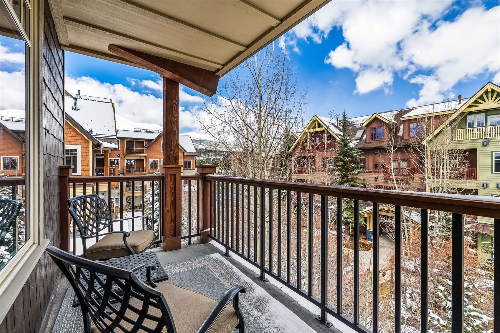 600 Columbine Road, Unit 5305 Breckenridge, CO 80424 - Photo 18 of 36 a view of a balcony with wooden chairs