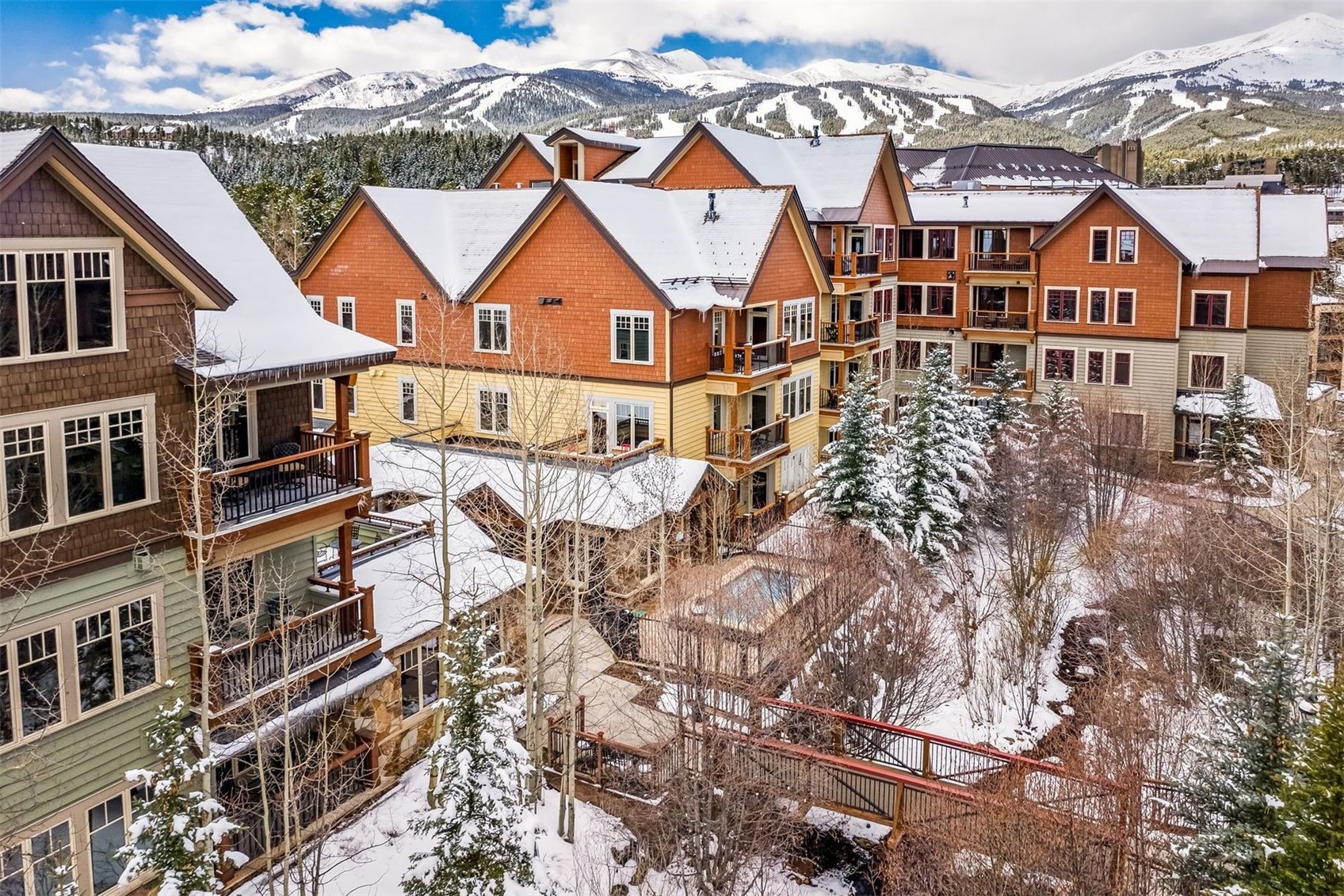 600 Columbine Road, Unit 5305 Breckenridge, CO 80424 - Photo 26 of 36 an aerial view of a residential apartment building with a yard and balcony