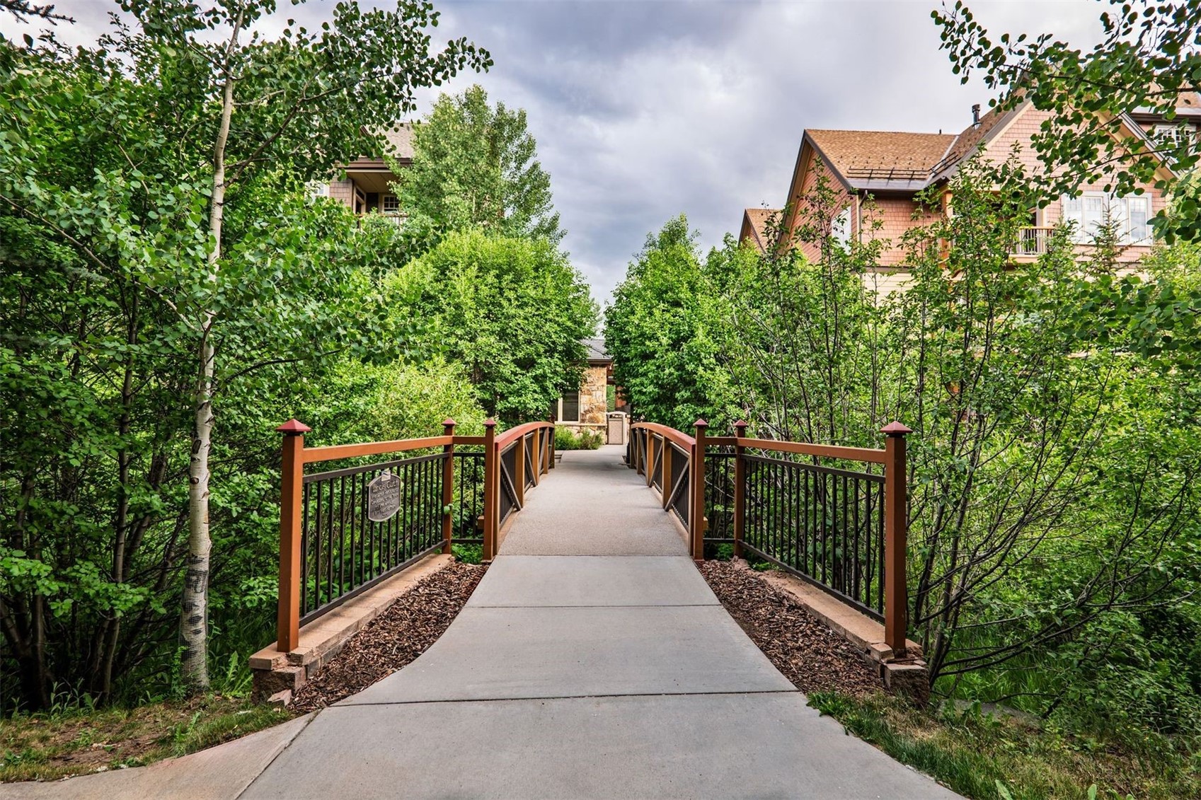 600 Columbine Road, Unit 5305 Breckenridge, CO 80424 - Photo 35 of 36 a view of a pathway with a wrought fence
