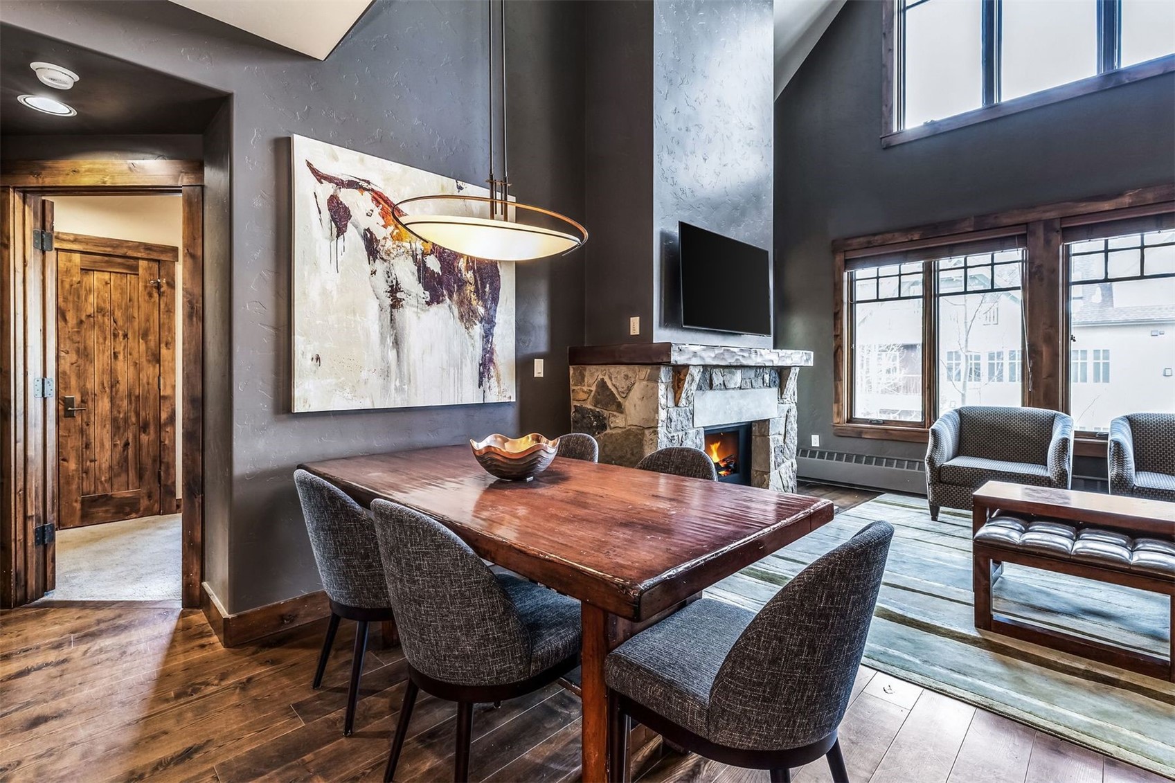 600 Columbine Road, Unit 5305 Breckenridge, CO 80424 - Photo 8 of 36 a dining room with furniture a fireplace and wooden floor
