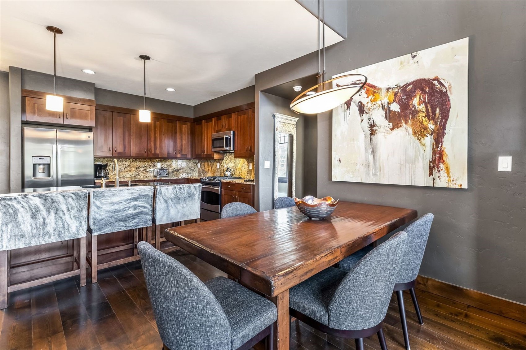600 Columbine Road, Unit 5305 Breckenridge, CO 80424 - Photo 9 of 36 a kitchen with a table chairs and a wooden floor
